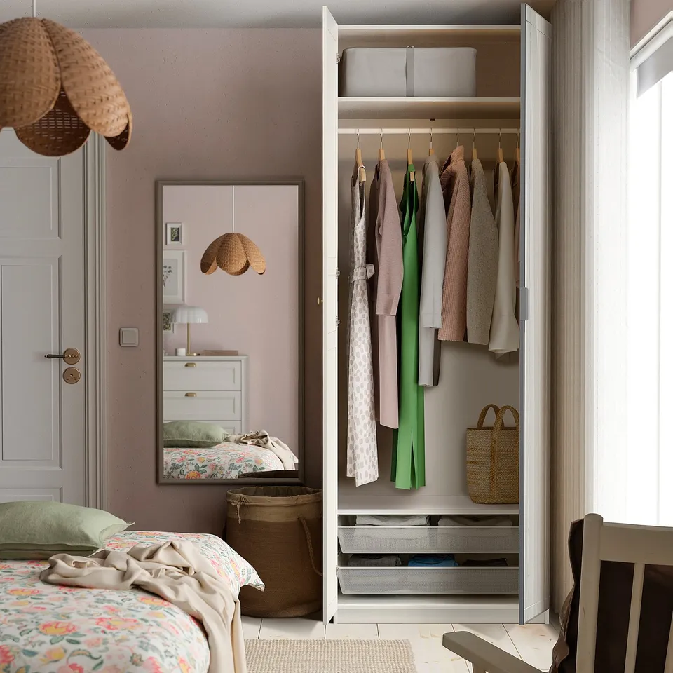 Organised bedroom with wardrobe and mirror.