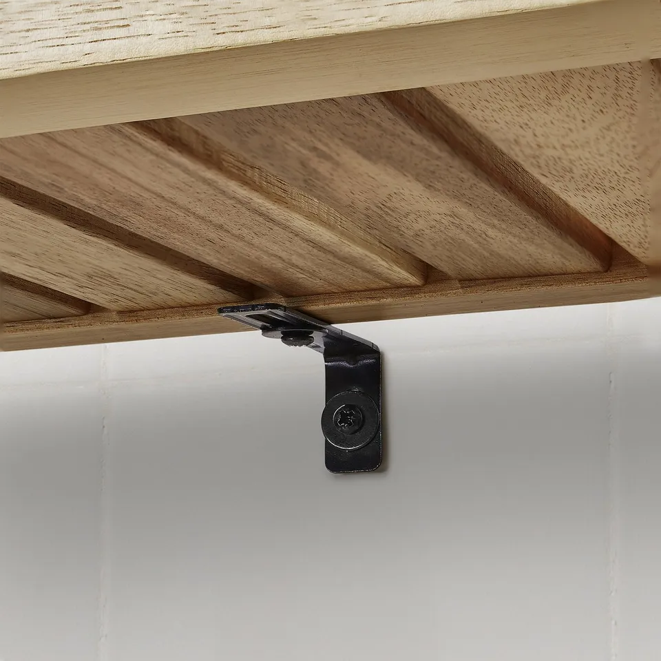 Metal bracket securely supports wooden shelf, showing sturdy assembly with acacia wood texture and black hardware.