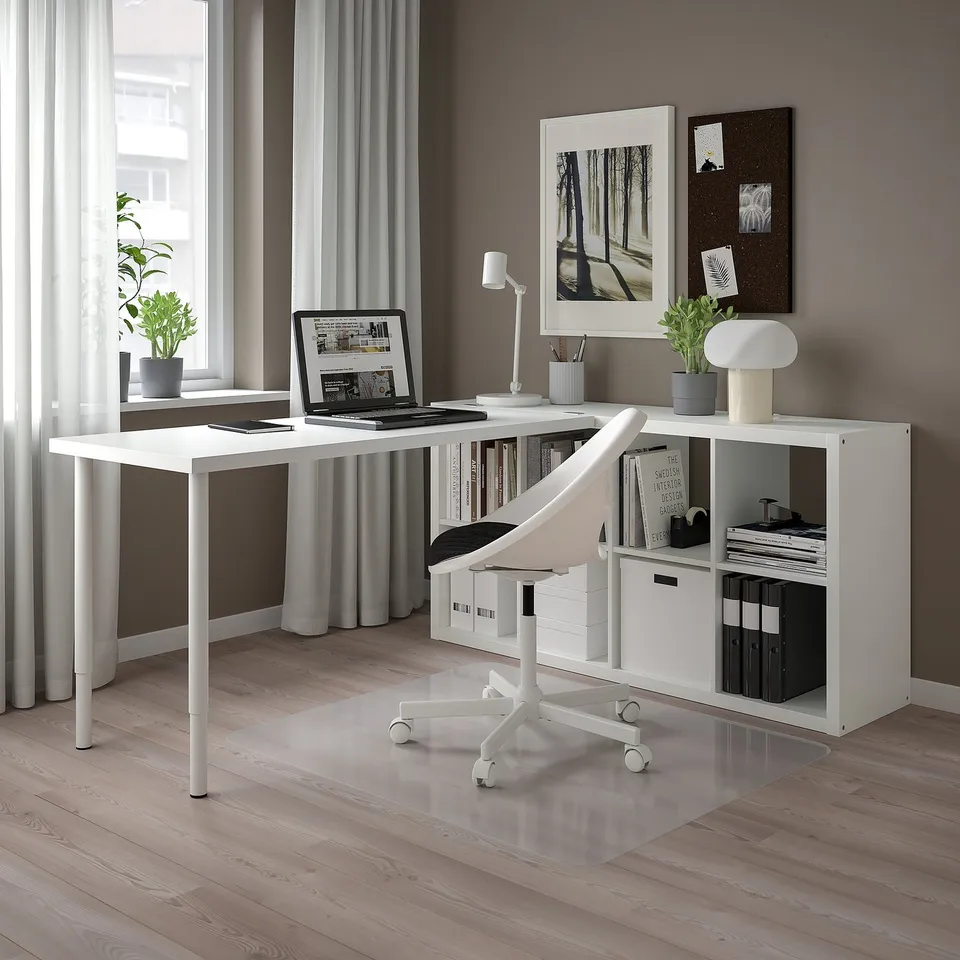 KALLAX shelving with tabletop, modern office setup, books, lamp, plant.