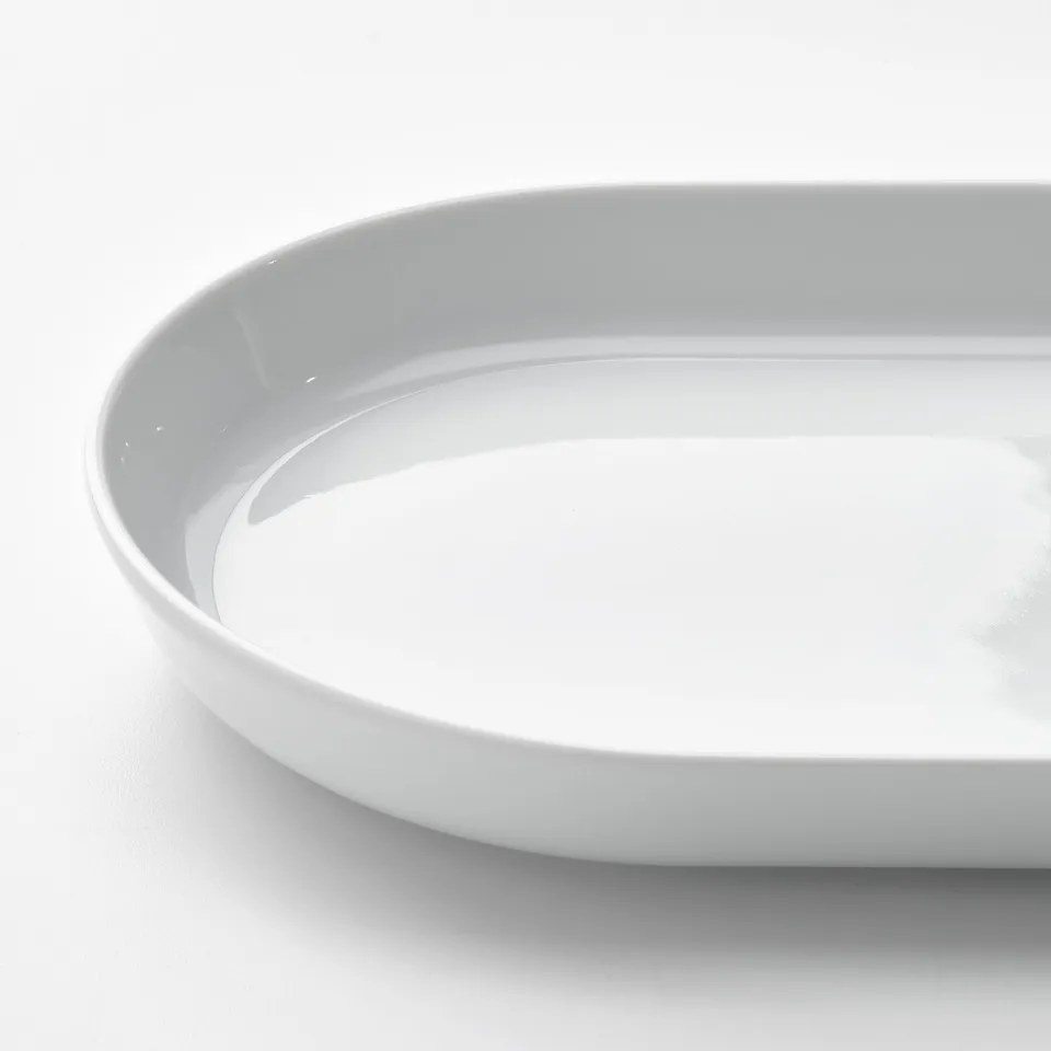 Crisp, white porcelain plate with sleek rim details, exuding simplicity and durability.