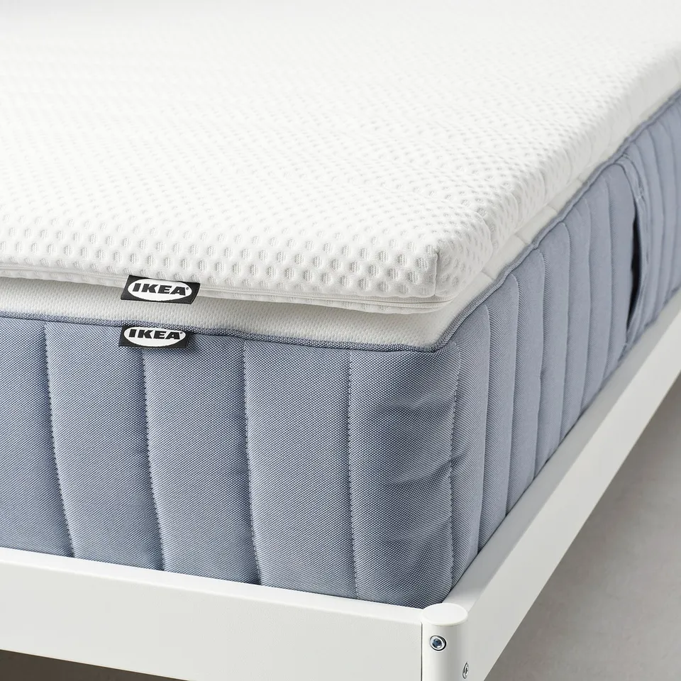 IKEA NISSEHOLM mattress pad, white and grey, firm feel, 5 cm thick, machine washable cover.
