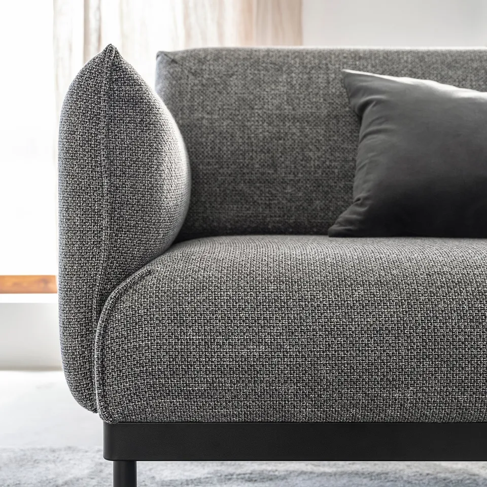 Modern grey fabric sofa, sleek metal legs, two cushions, minimalist design.
