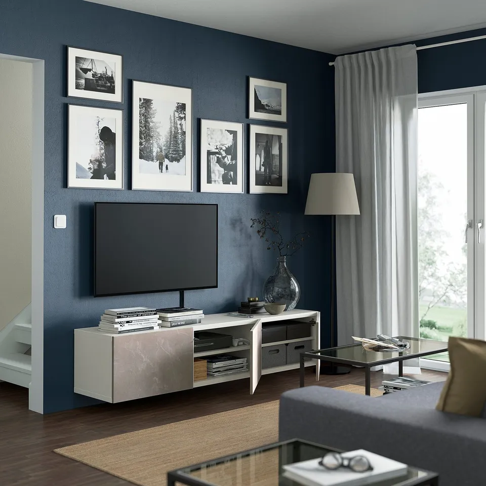 Modern living room with BESTÅ tv bench, flat-screen tv, and decor.