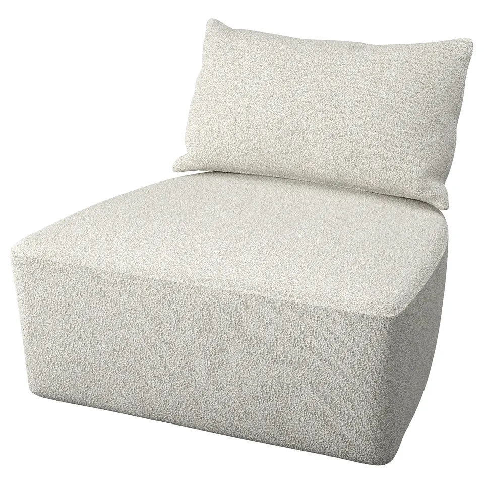 A light beige, cushioned chair with a rectangular pillow. It has a boxy, modern design and is covered in a textured fabric.