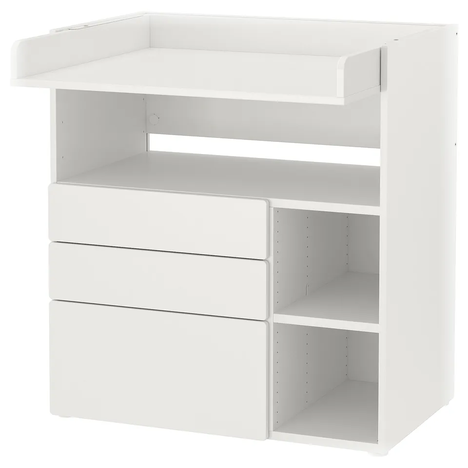 White baby changing table with drawers and shelves.
