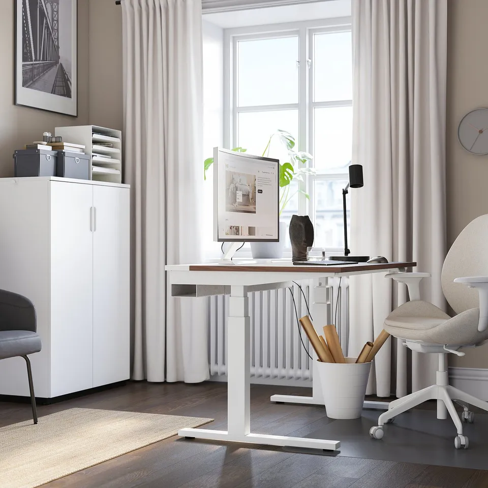 Modern office setup with MITTZON white sit-stand desk, ergonomic chair, and sleek accessories.