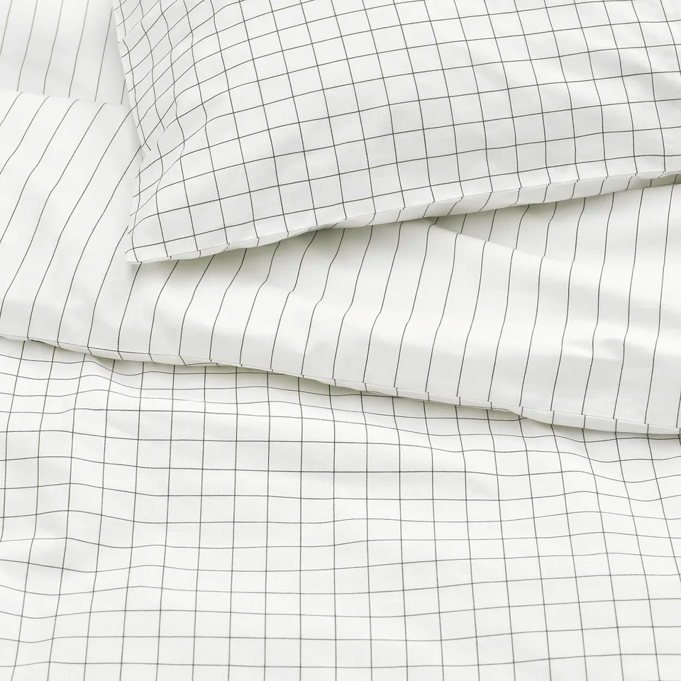 Crisp white duvet cover with stitched grid pattern, high-quality cotton fabric, and neat seam details.