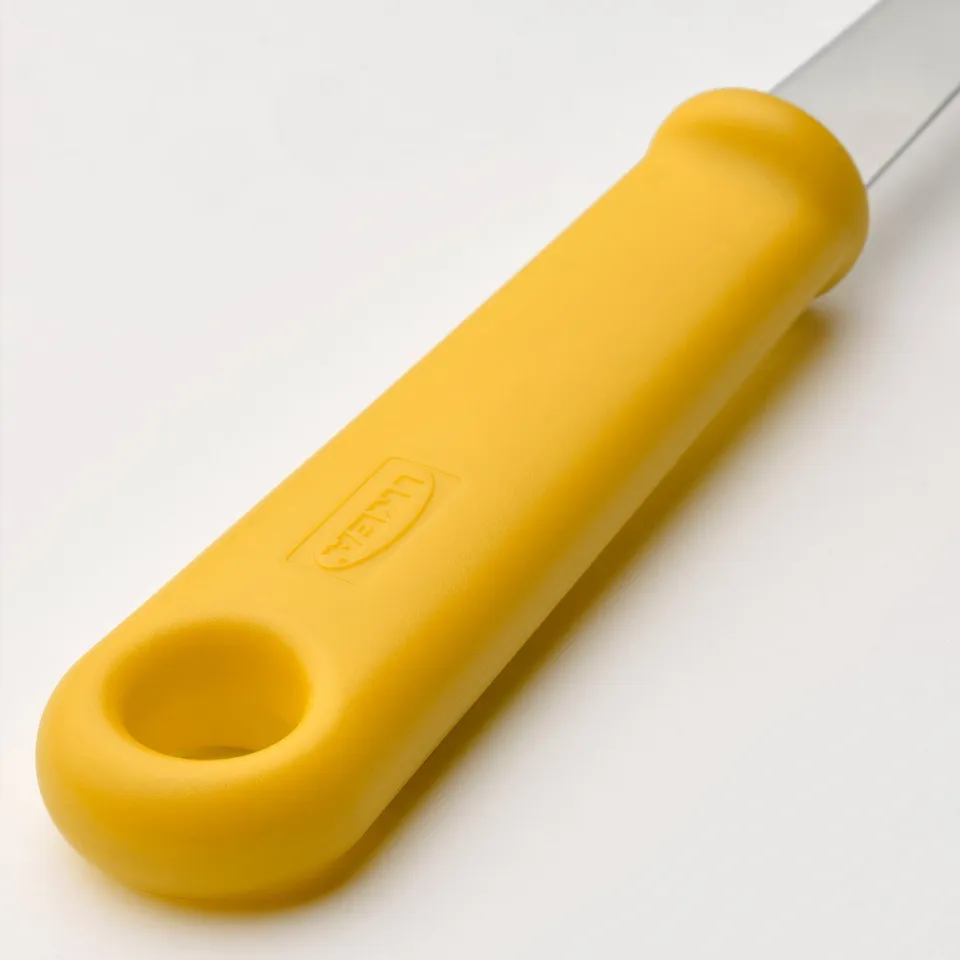 Bright yellow-handled knife with stainless blade, part of IKEAs UPPFYLLD set. Designed for precise peeling and cutting.