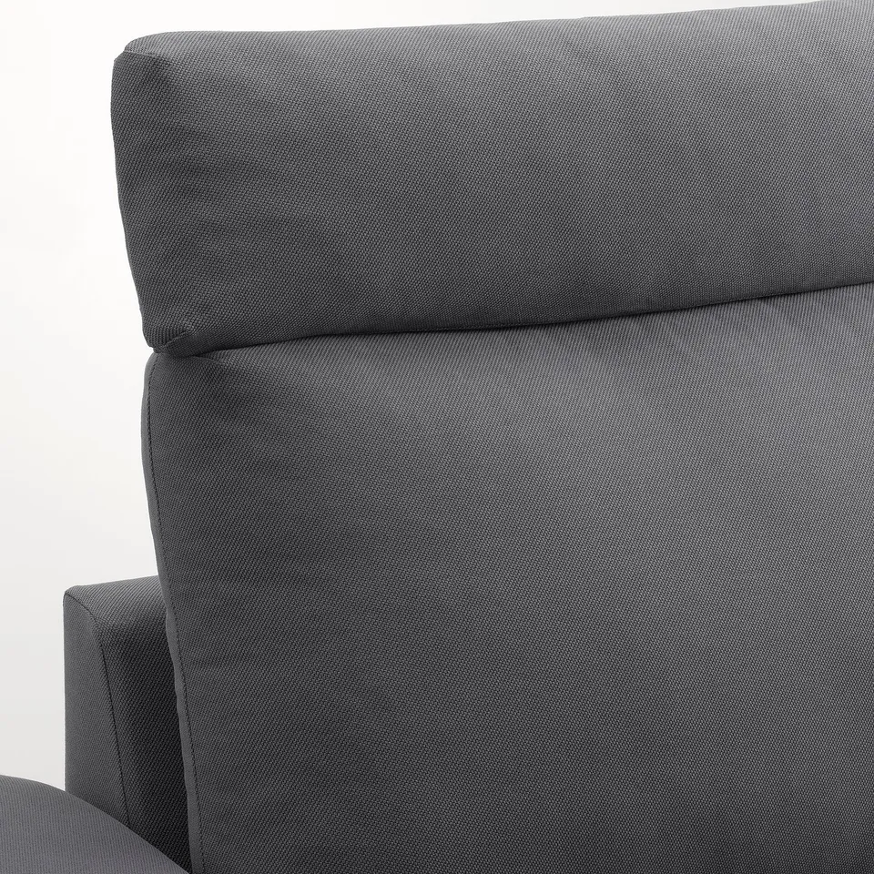 A close-up of a VIMLE sofa in textured dark grey fabric, showcasing its plush, supportive headrest and sturdy, comfortable design.