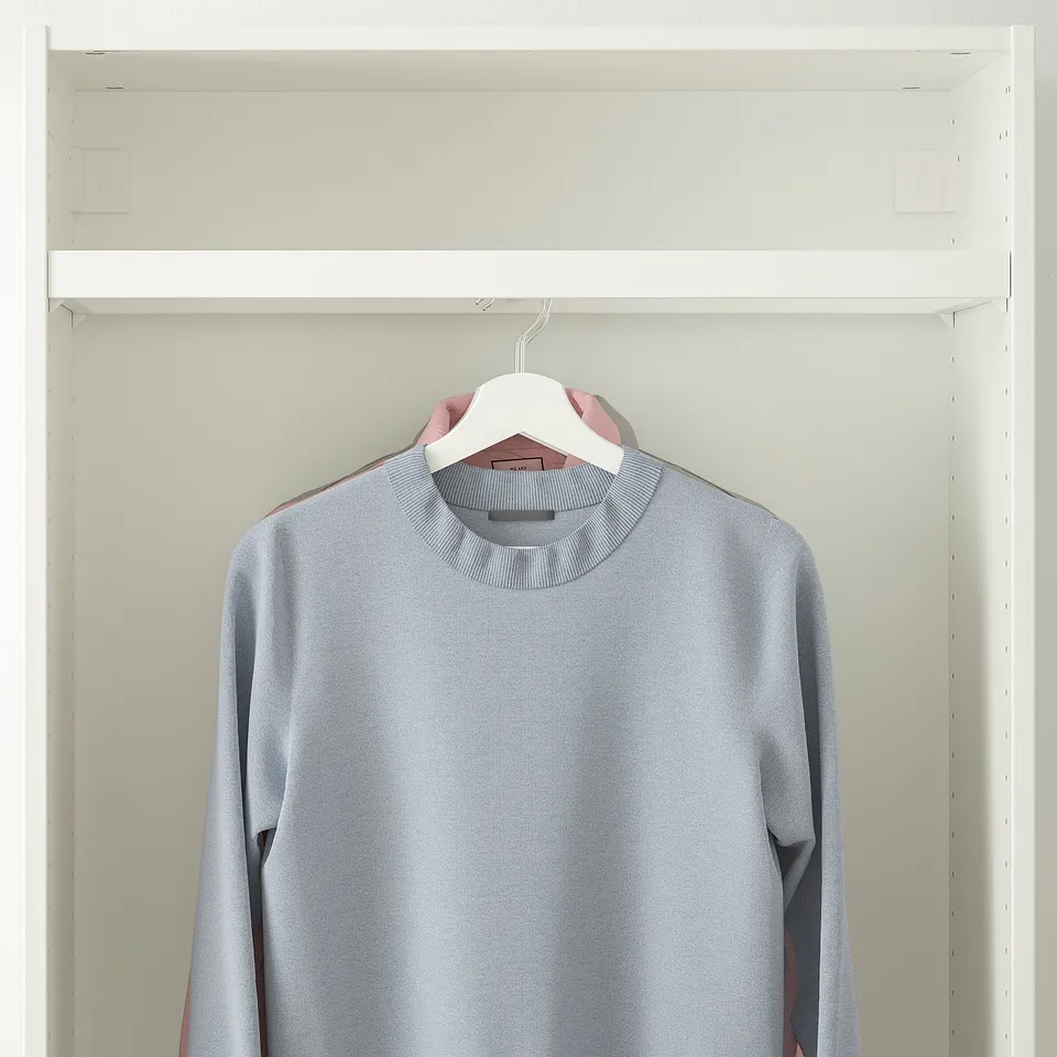 Grey sweater on white hanger in white closet.