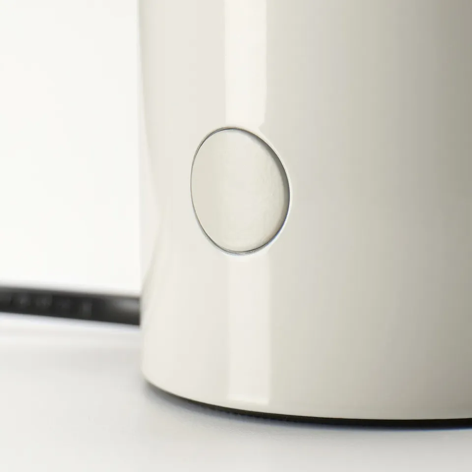 Close-up of sleek, modern white table lamp with circular power button.