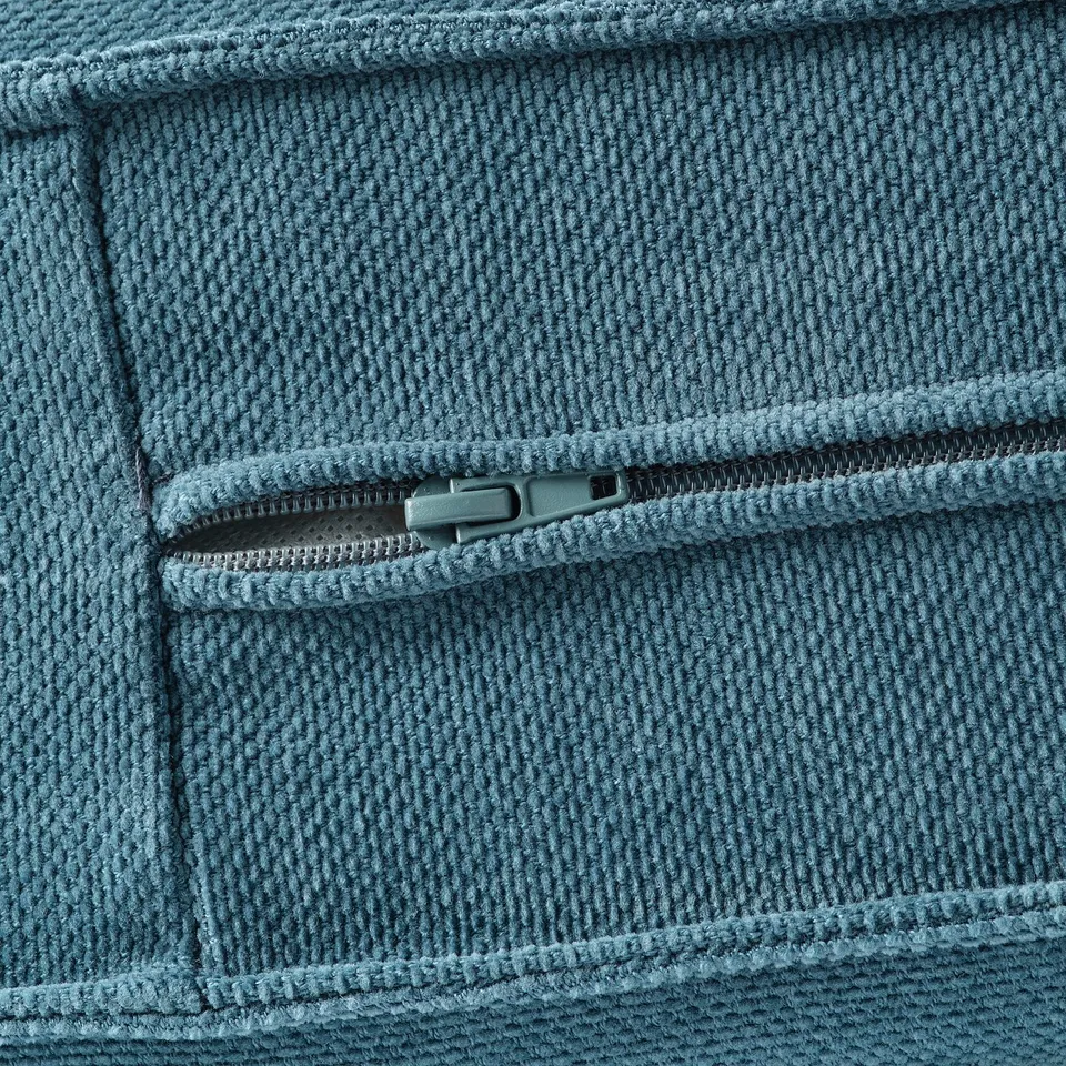Close-up of soft, blue fabric with zip, showcasing high-quality texture and fine stitching.