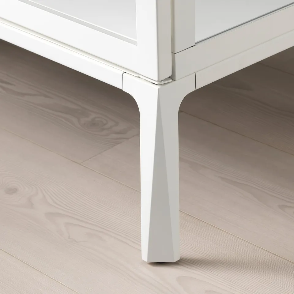 White table leg on wood floor.