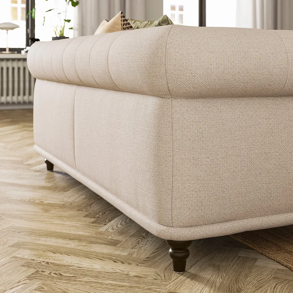 Beige VISKAFORS sofa, classic design, soft rounded shapes, light wood floor.