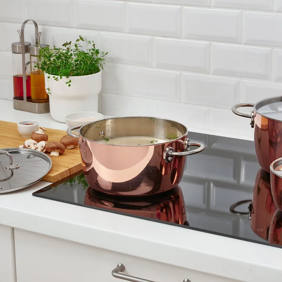 Modern kitchen, cooking soup on induction stove.