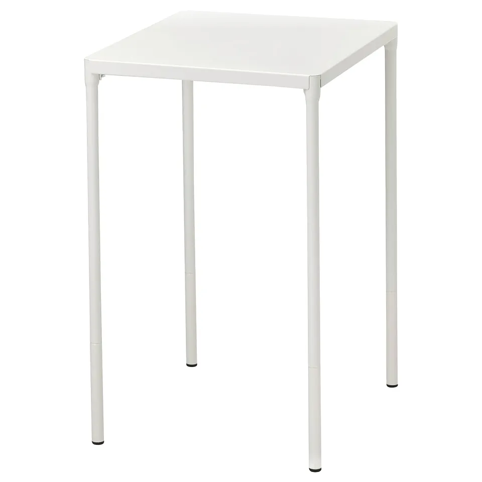 A white FEJAN outdoor table with a square top and metal legs. Its sleek and modern, made for easy maintenance.