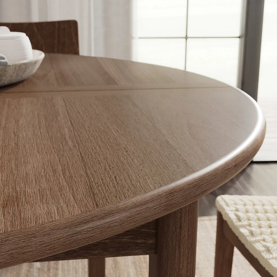 Modern, brown, round dining table with smooth edges and a sleek design, ideal for social gatherings.