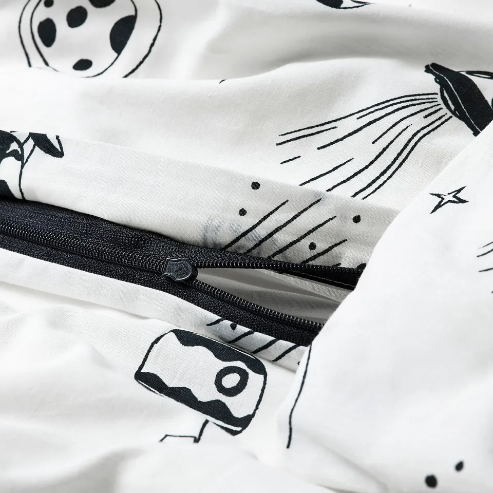 Black-and-white space-themed duvet, zip open, showing inside.