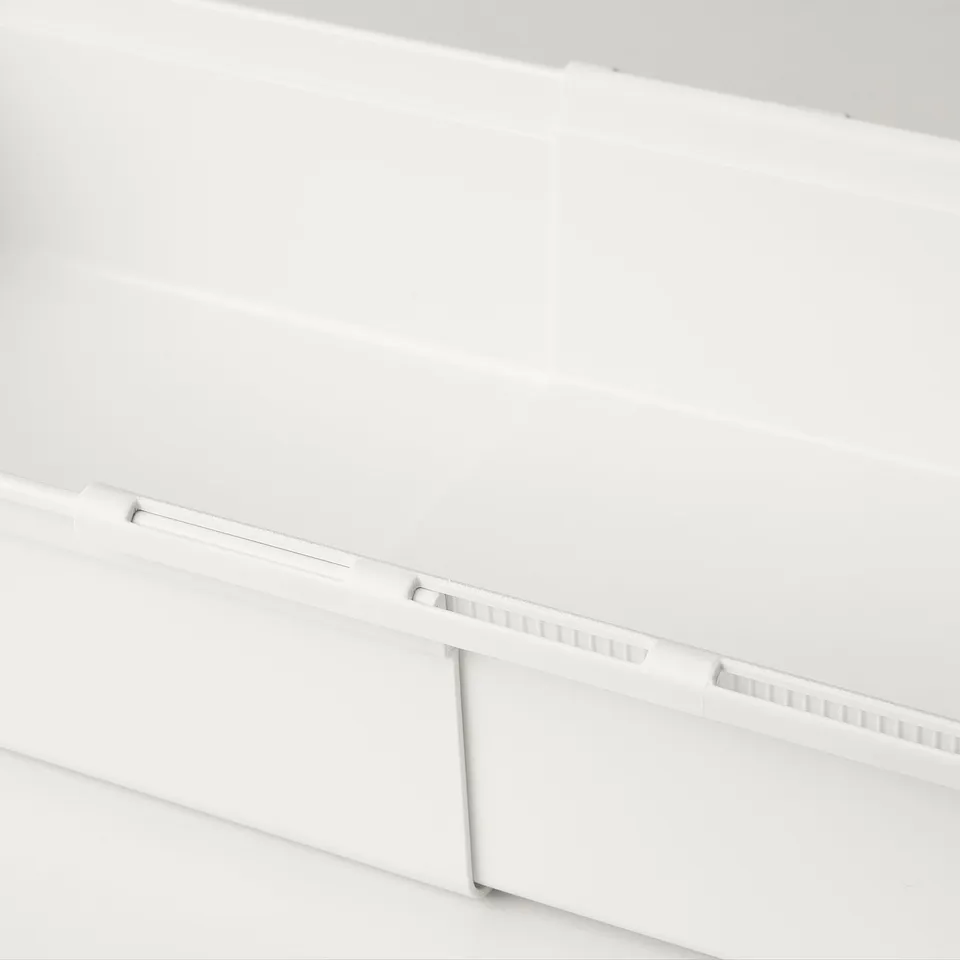 White extendable plastic storage box part seen, sleek design, seamless fit.