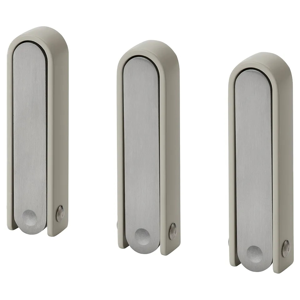 Three silver KLYKET hooks with wavy shape, perfect for hanging items, folds flat, versatile design.