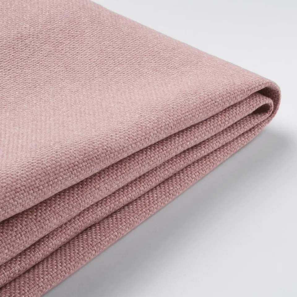 Closeup of folded pink fabric, showcasing texture and quality, likely an upholstery sample.