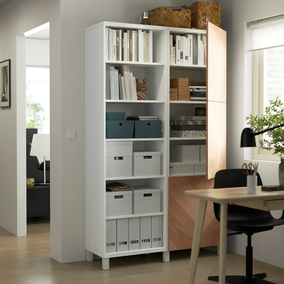 White BESTÅ shelving unit with adjustable compartments for both hidden and open storage, ideal for organising and displaying items.