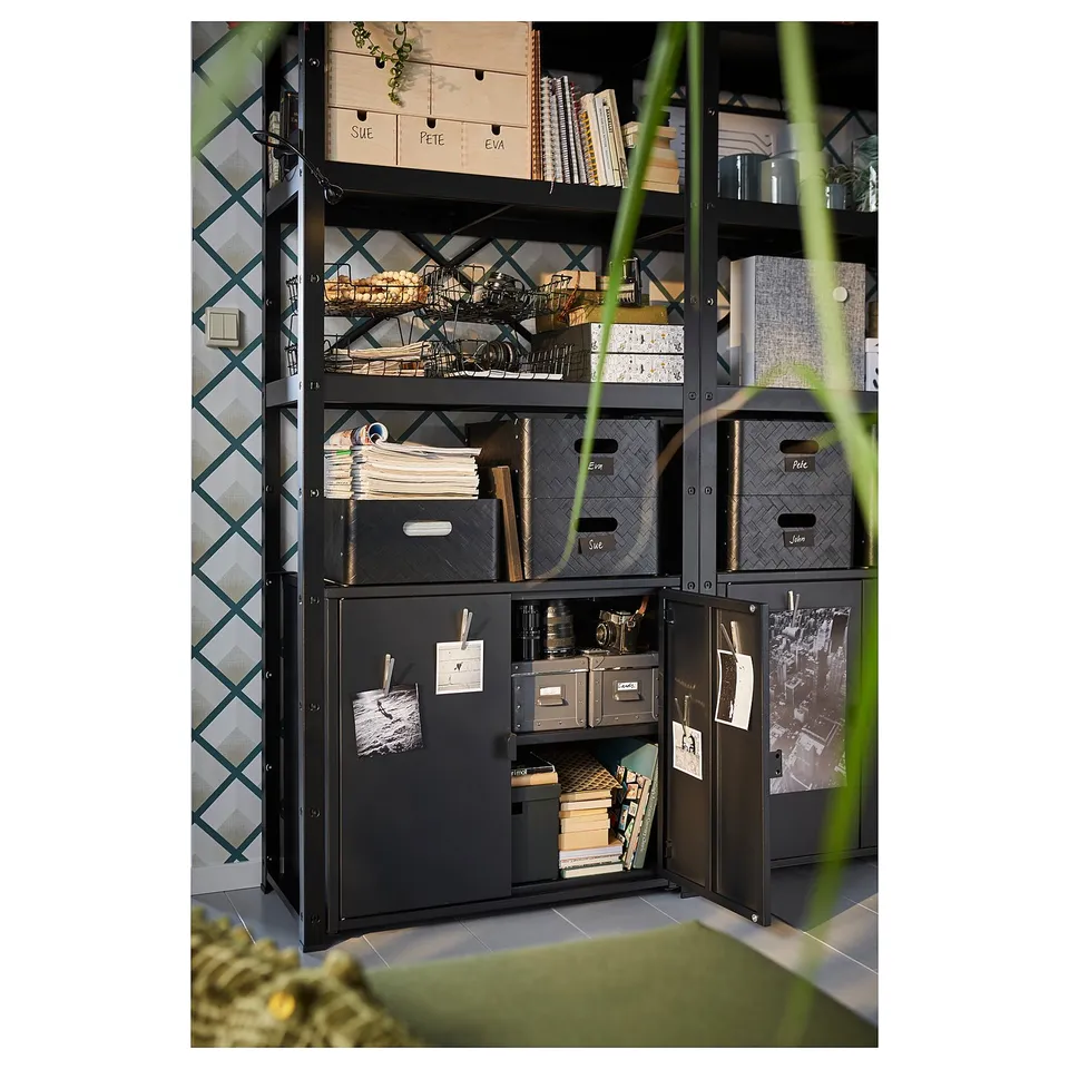 Black metal storage unit with shelves and drawers, holding various items. Temperature control inside. Part of BROR system.