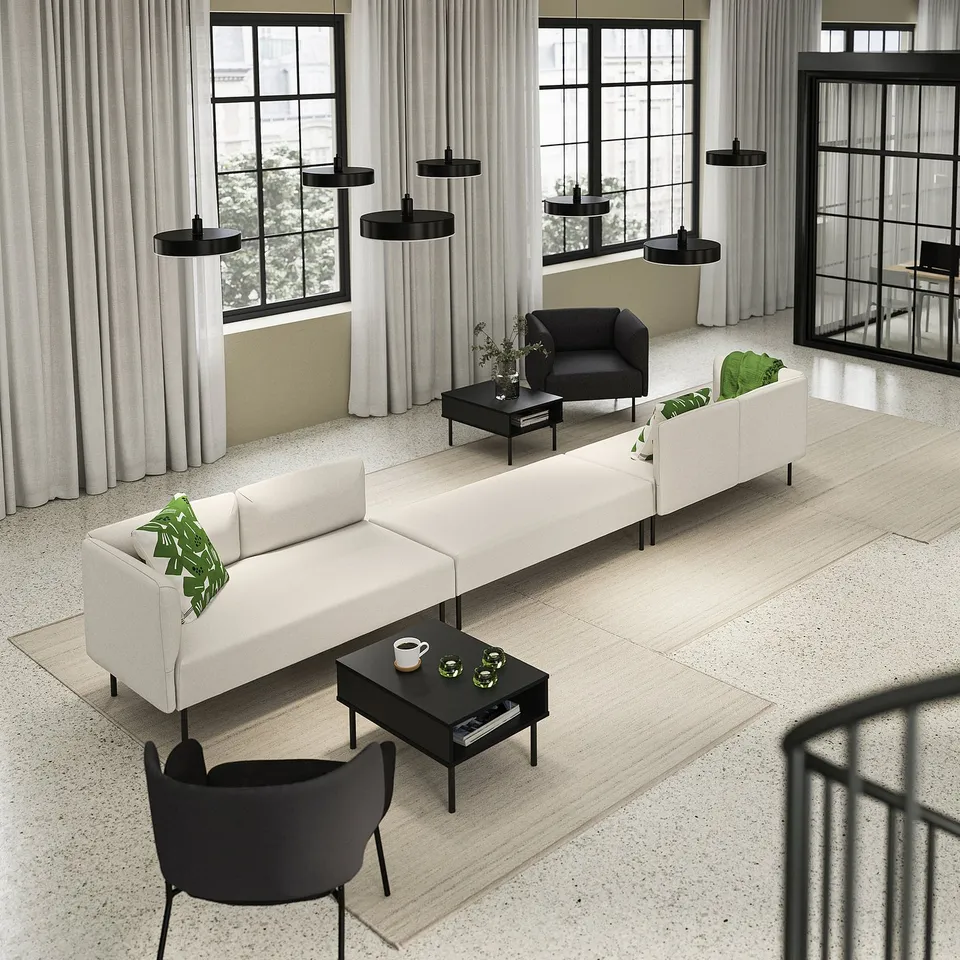 Modern living room with TUNSTA black coffee tables, white sofas, black chairs, green plants, and black pendant lights. Large windows with curtains.
