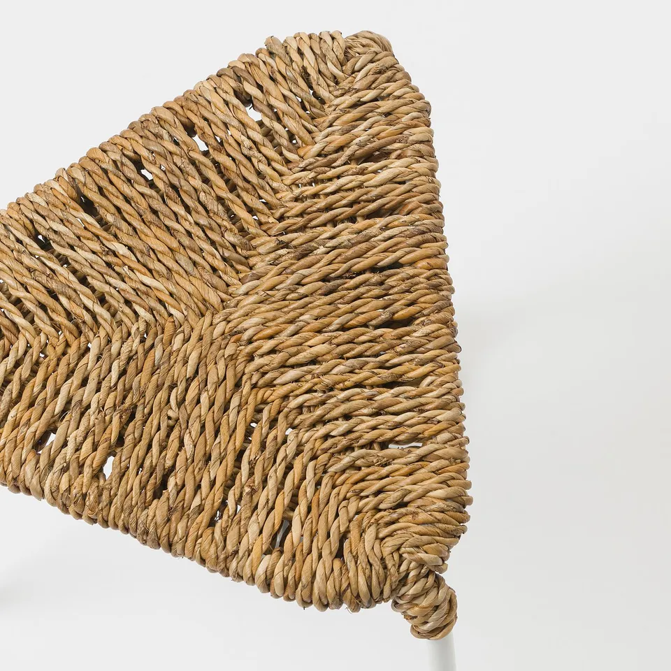 Handwoven banana fibre seat on sturdy metal frame, beautifully crafted.