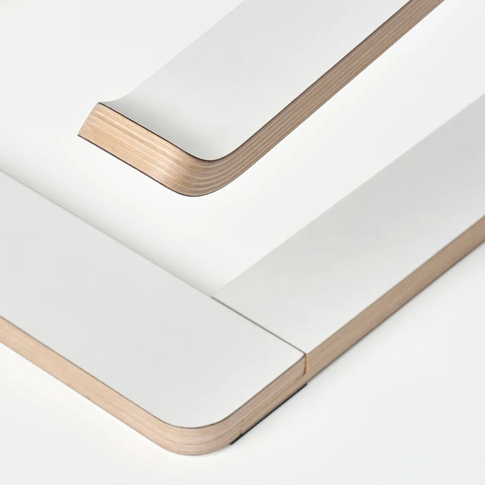 Minimalist wooden laptop stand, angled for ergonomic use.