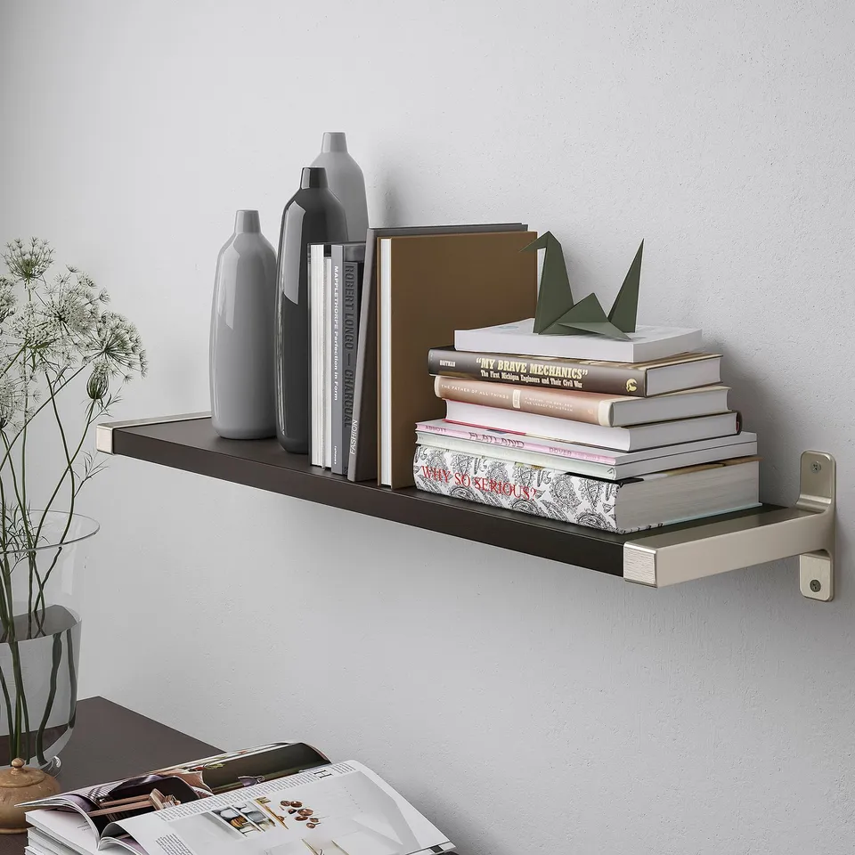 Wall-mounted shelf with bevelled and smooth edges, holding books and vases.