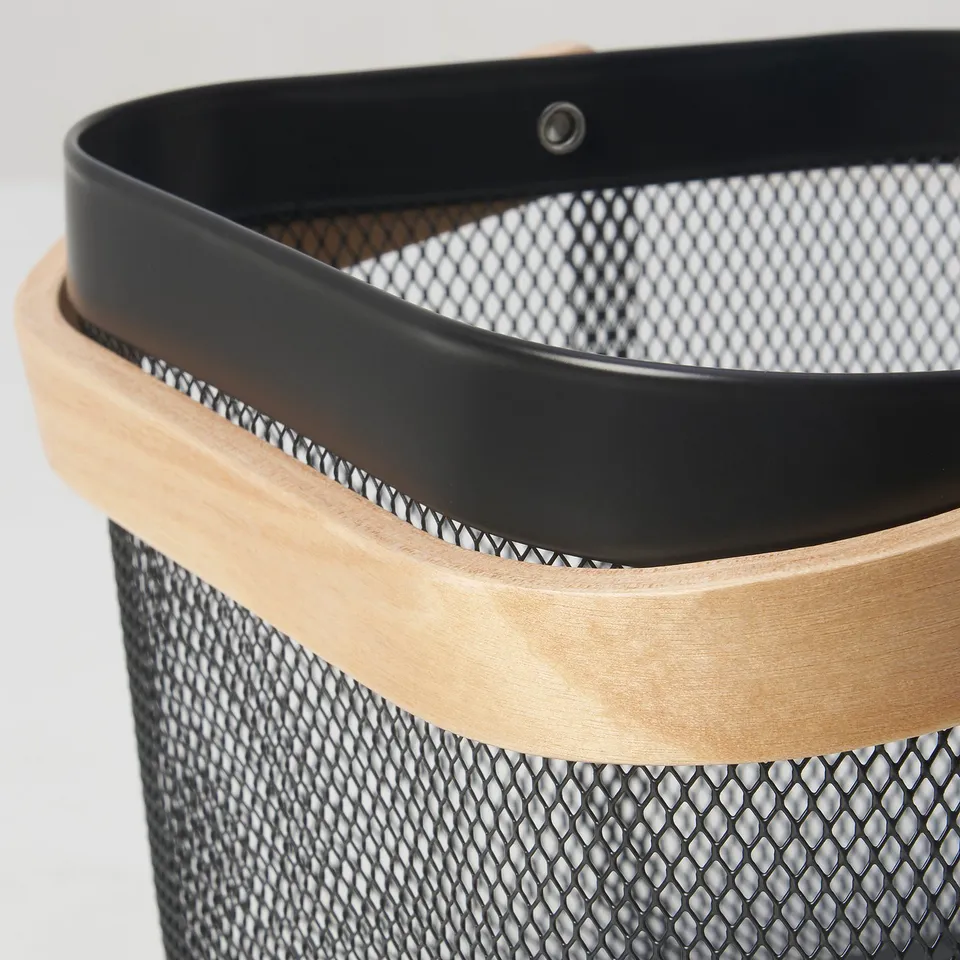 Black mesh basket with wooden handle; sturdy, modern design.