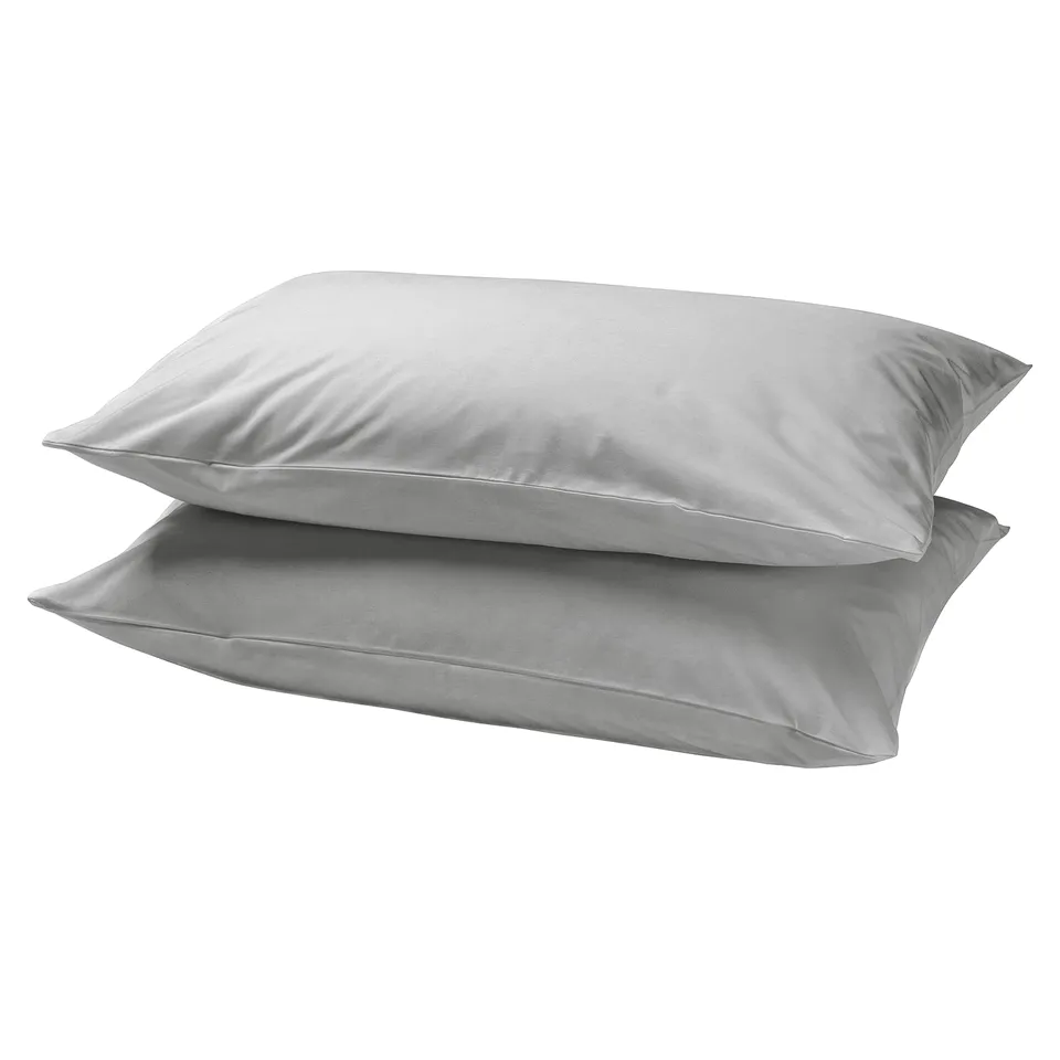 Two silver-gray, square-shaped pillows stacked neatly, smooth and serene.