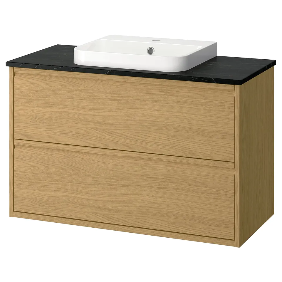 Modern oak bathroom vanity with black countertop and square white basin.