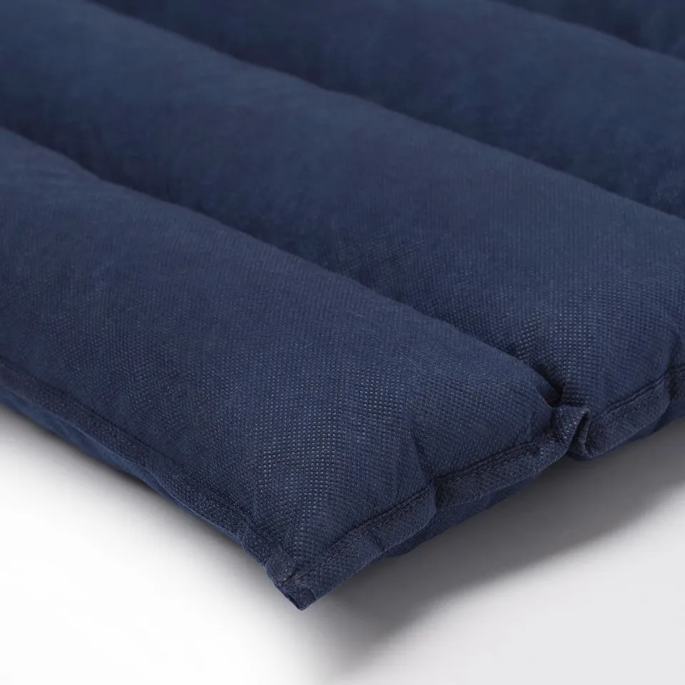 Navy blue rolled-up futon mattress, showcasing its soft foam filling and sturdy non-woven cover, ready for comfortable sleep or easy storage.