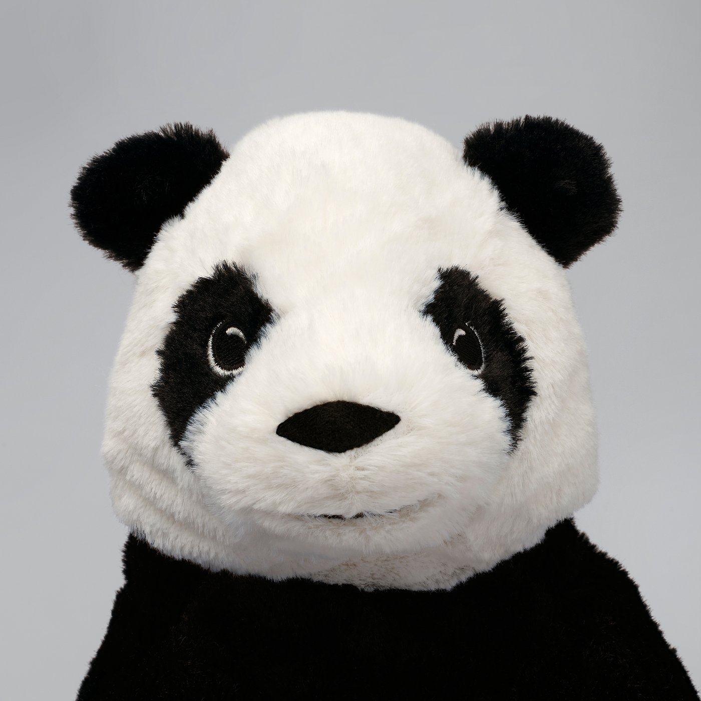 Cute plush panda toy, well-made with soft white and black fabric, detailed perfect for cuddling.