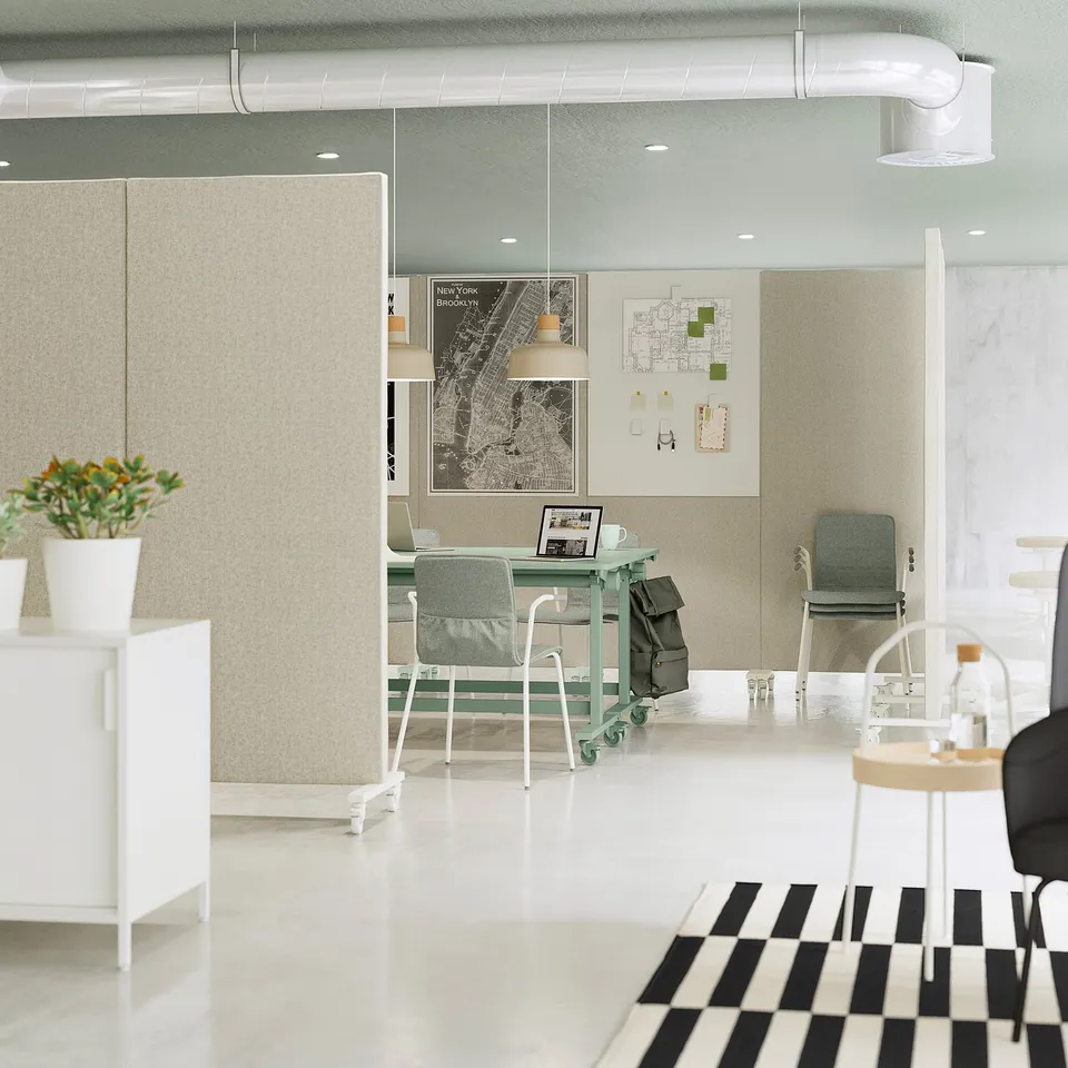 Modern office with MITTZON furniture and plant. Tables fold, chairs stack, map on wall.