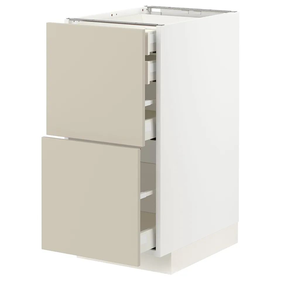 A beige METOD kitchen cabinet with two open drawers, featuring a modern design and a smooth finish.