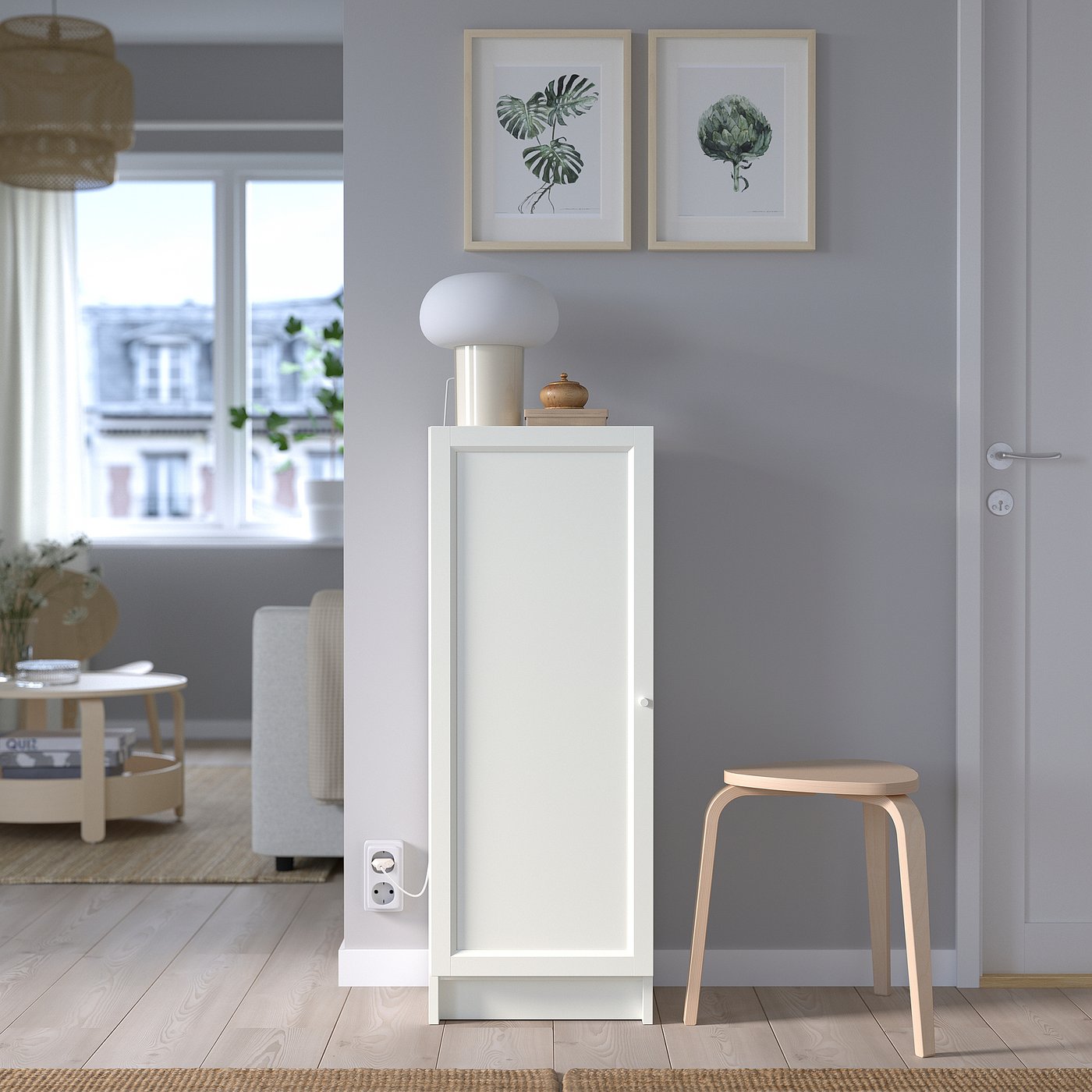 Minimalist room with BILLY white cabinet, blue wall, wooden stool, lamp, and botanical prints.