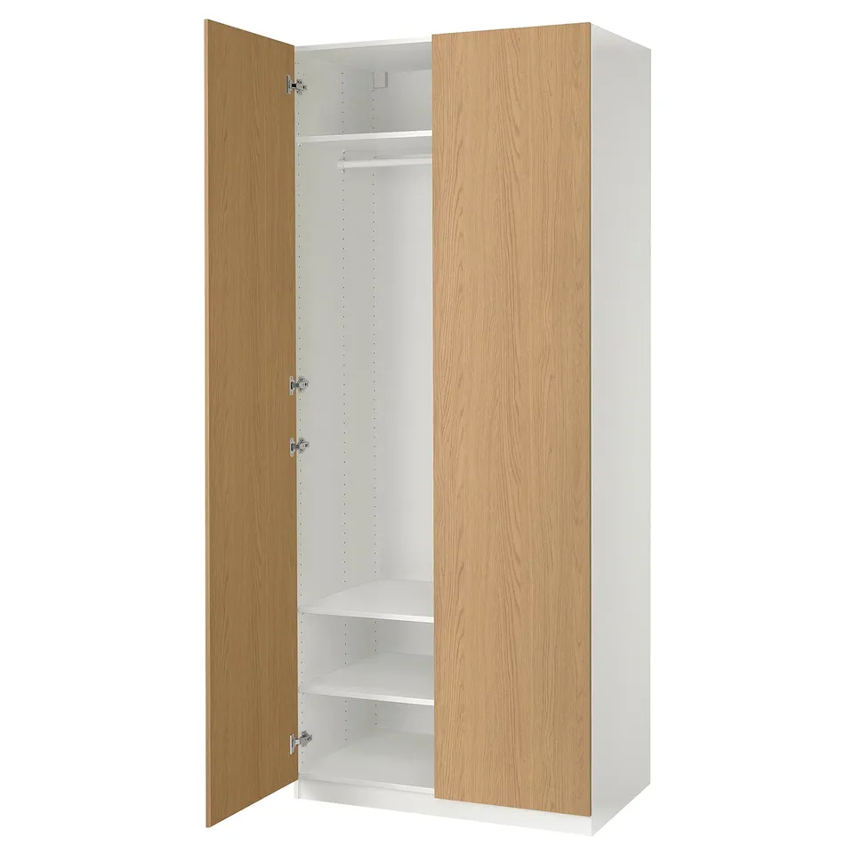 PAX wardrobe with light wood doors, white interior, soft-close hinges.