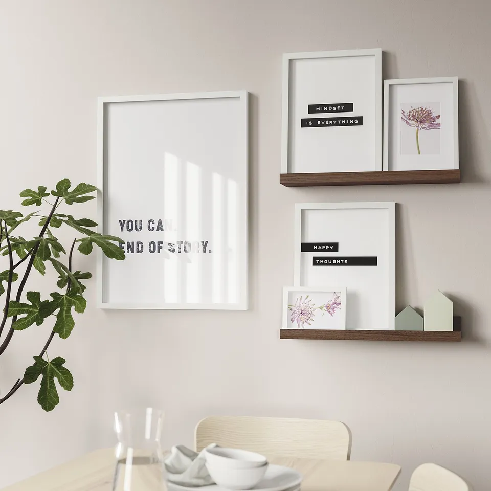 Wall-mounted shelves display pictures and decor, showcasing motivational quotes and floral art, enhancing home decor.