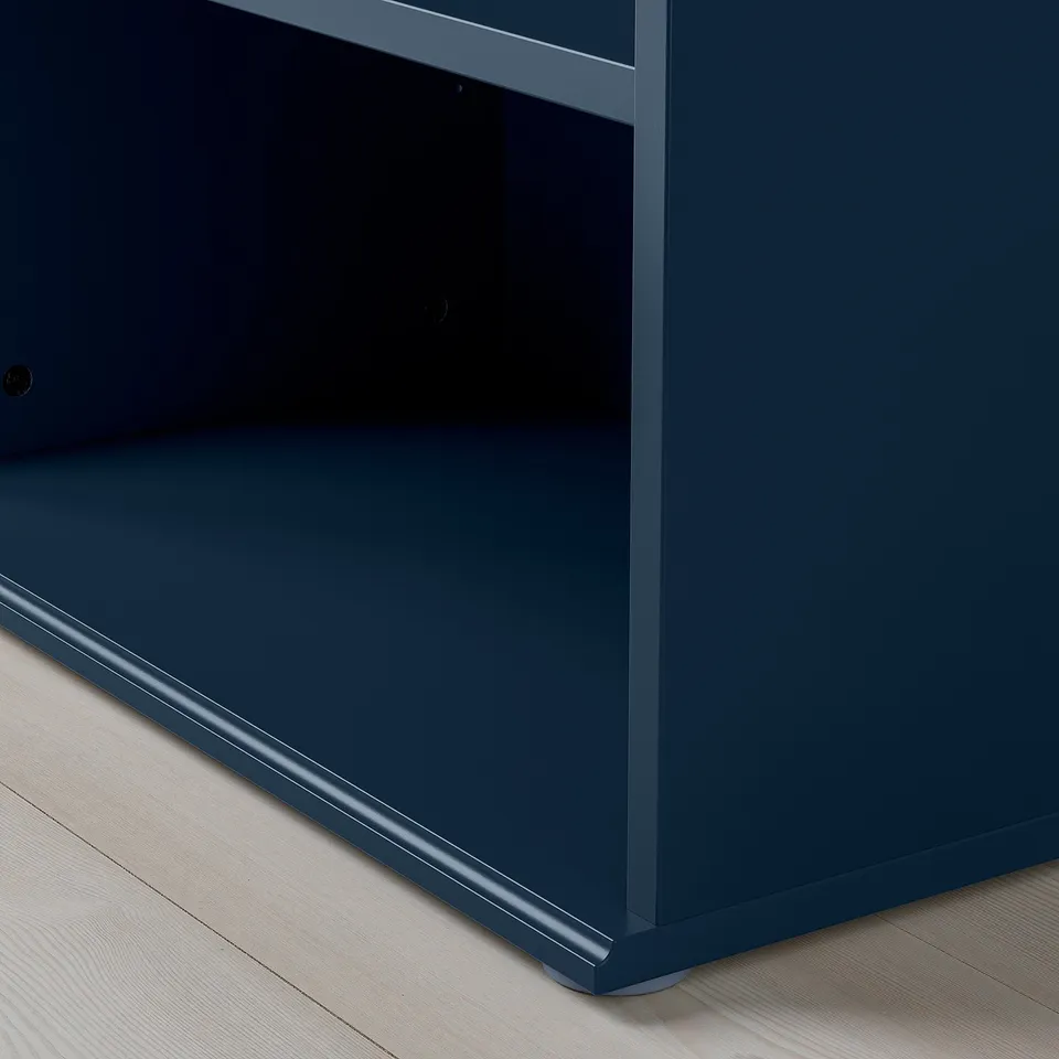 Navy blue SKRUVBY cabinet with sleek, modern design and adjustable feet for stability.