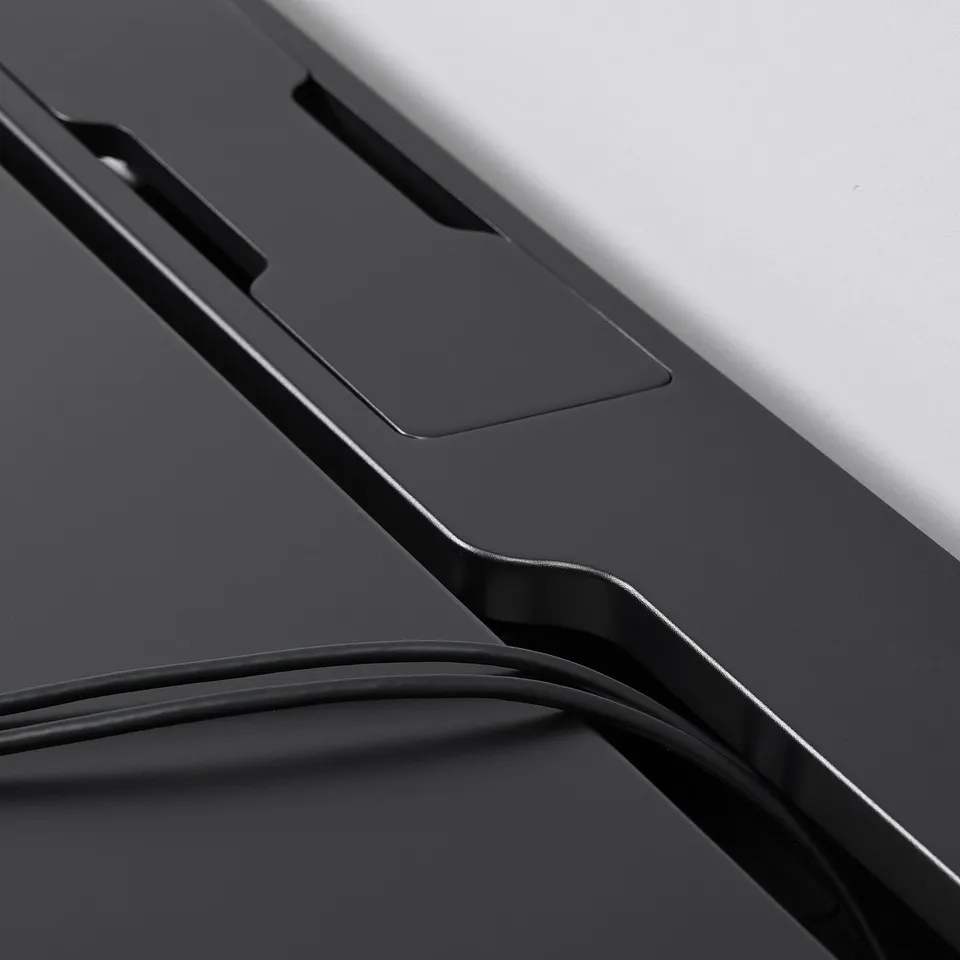 Close-up of sleek, matte gaming desk, showcasing sturdy design, smooth surface, and neat cable slot.