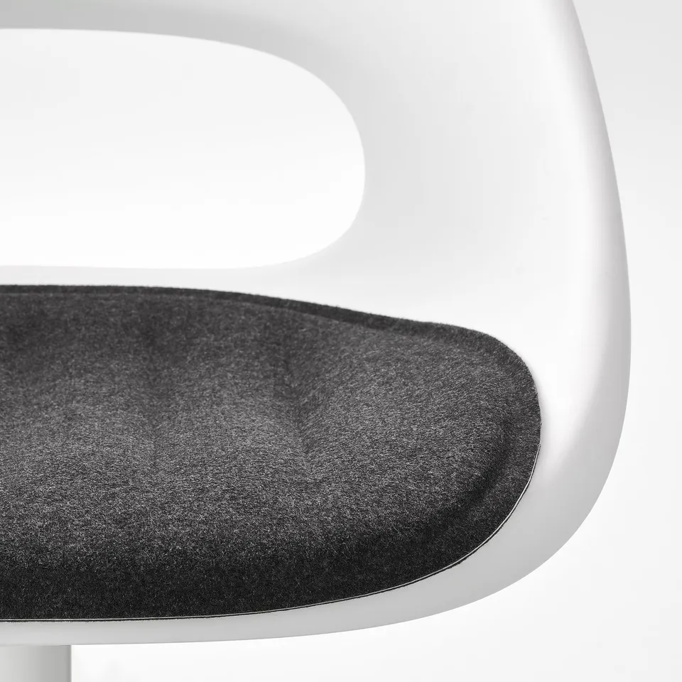 Image shows close-up of modern chairs seat and edge, displaying sleek design and smooth materials.