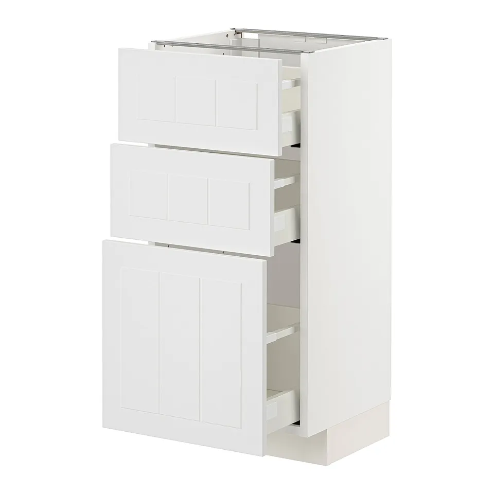 An ikea METOD kitchen cabinet in white with wooden panels and multiple drawers.