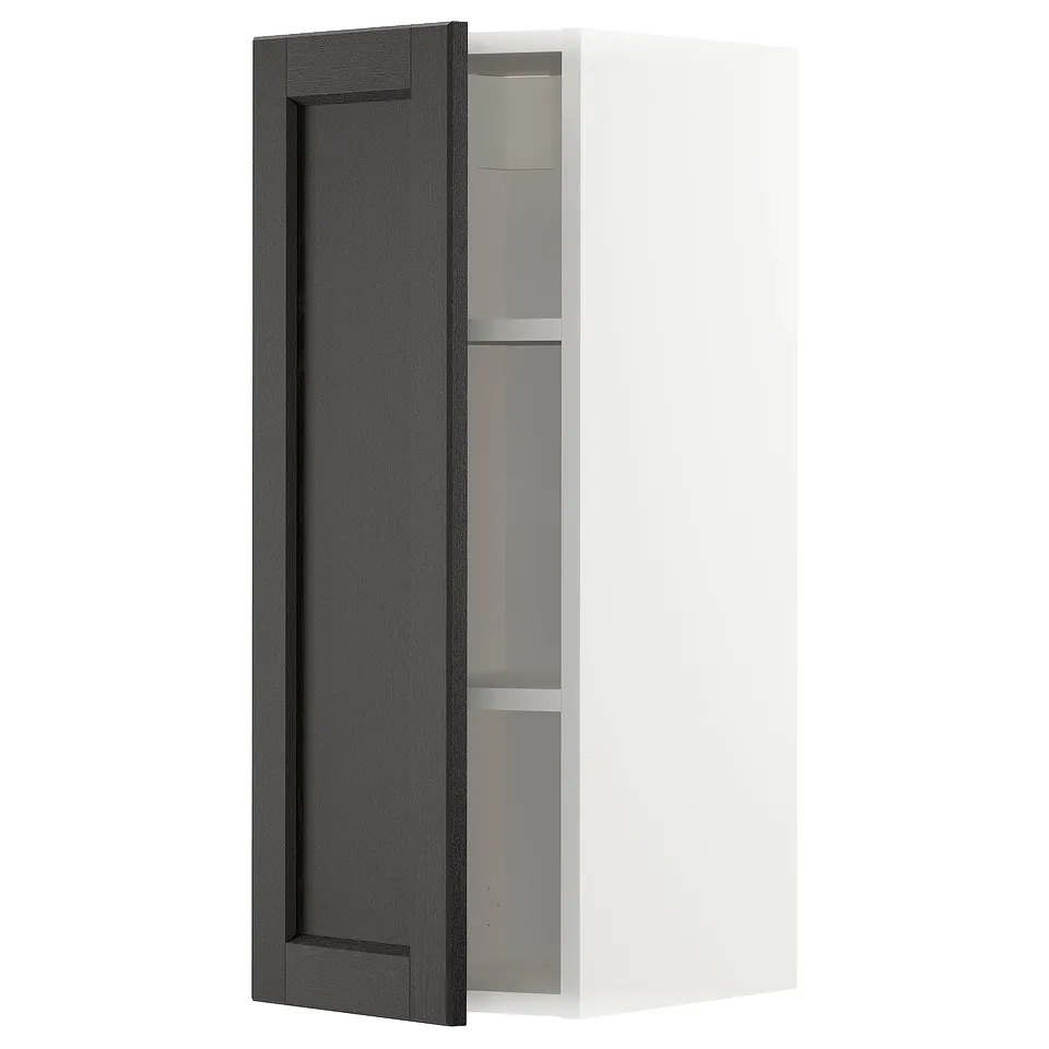 A white METOD kitchen cabinet with a single black stained wooden door featuring bevelled edges. It has an internal shelf and a modern design.