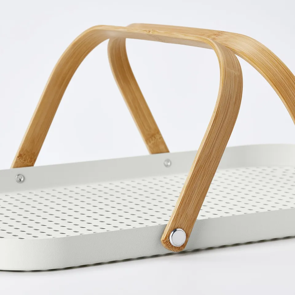 Modern bamboo-handled tray with perforated steel base for drainage; durable, stylish design.