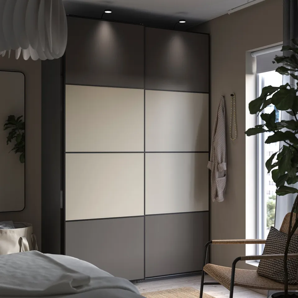 Modern bedroom with large sliding wardrobe, neutral tones, natural light, featuring MEHAMN door.