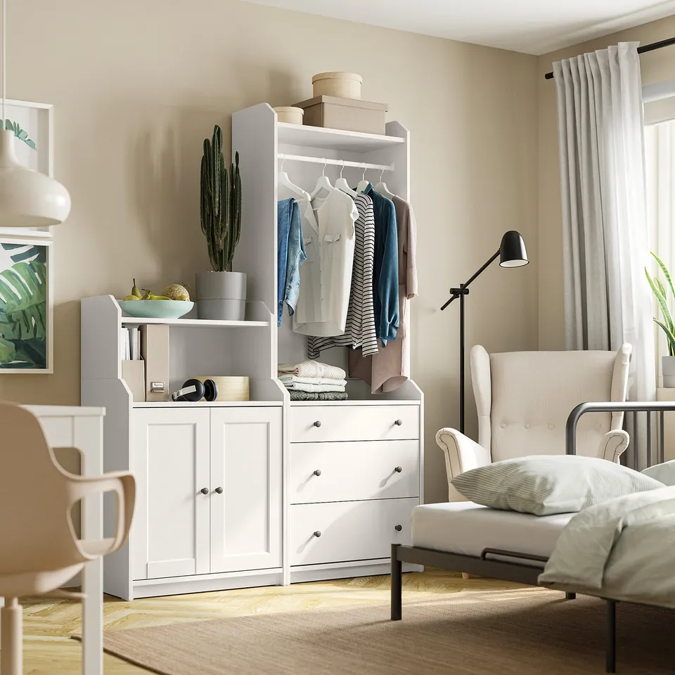 Beige room with white furniture, HAUGA unit, armchair, lamp, cactus.