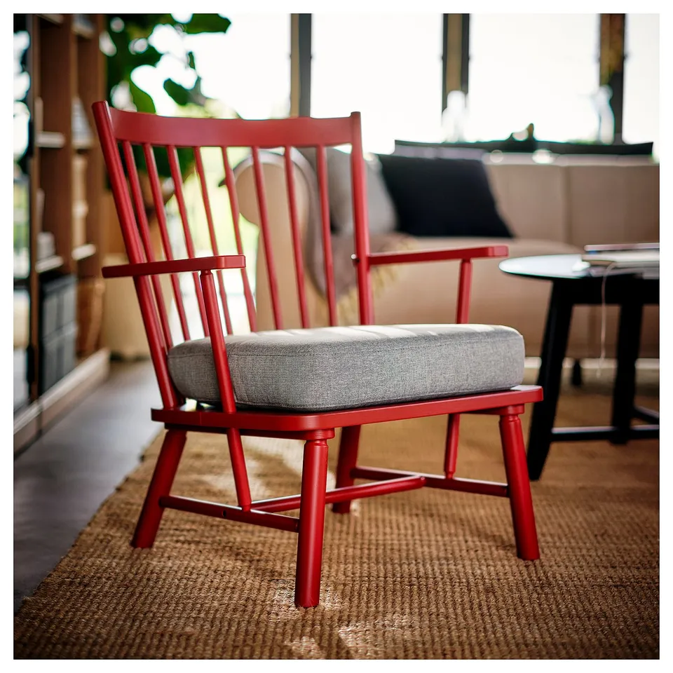 Red PERSBOL spindle chair with grey cushion, classic & comfy, fits cosy spaces.